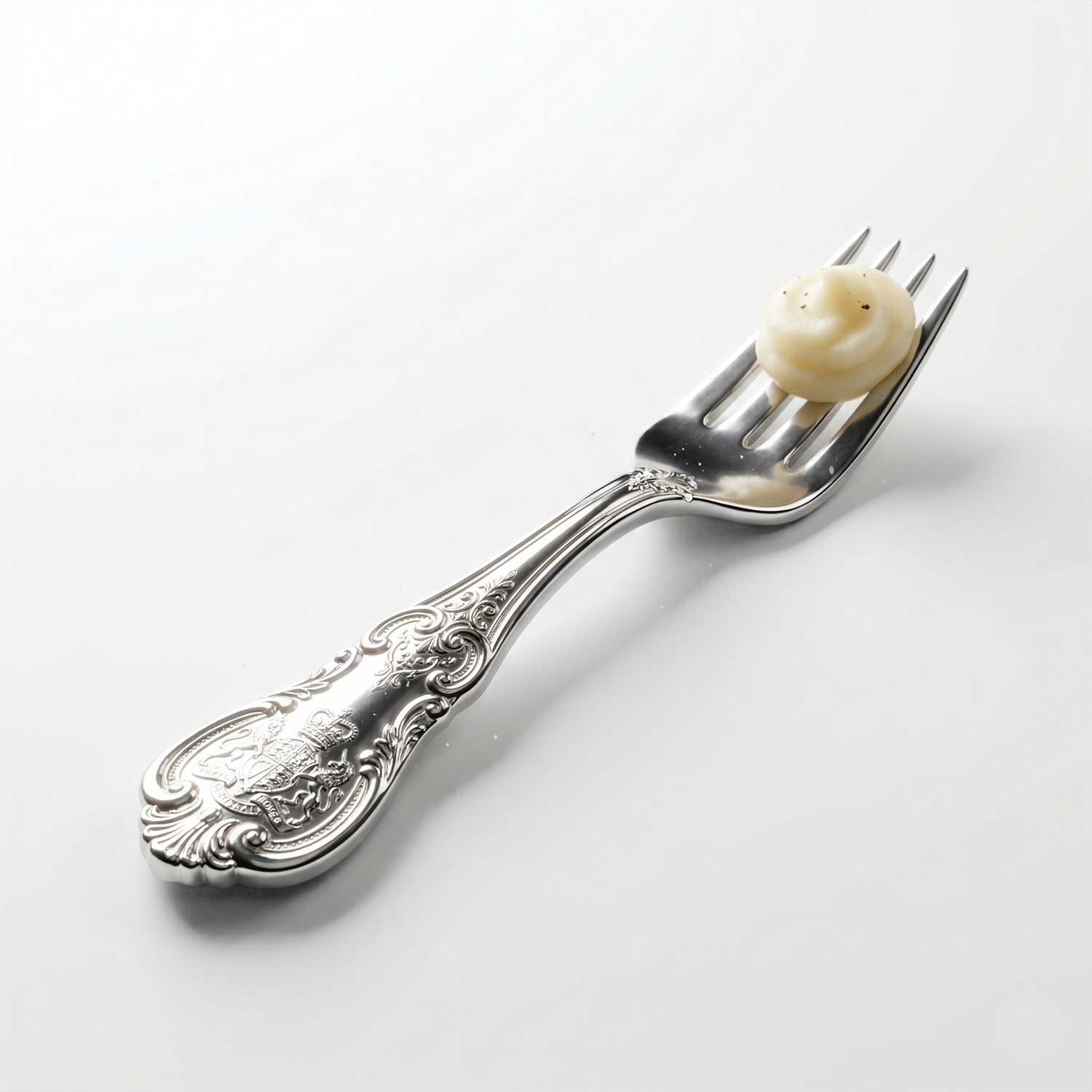 3D AI generated tiny ornate silver dining fork with royal engravings holding a tiny bite of creamy food on a white background by Inspirious Design